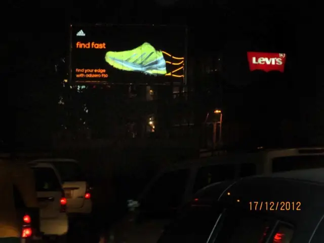 Levi’s and sneaker billboards at night