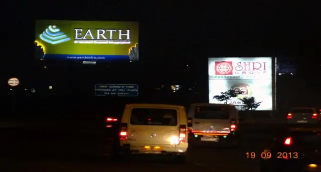 Earth hoarding over evening traffic